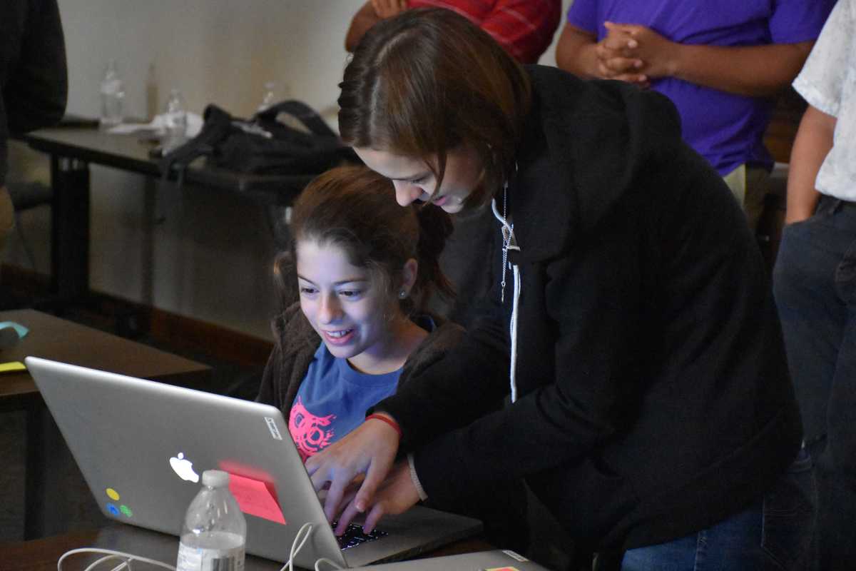 Family looking at game made during Gamecrash 2016 summer camp